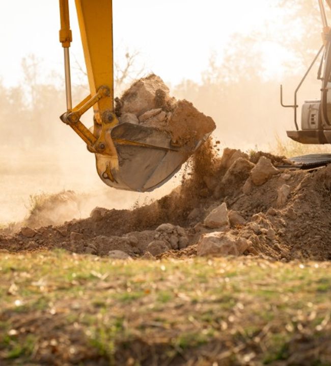 excavator bucket moving dirt on a jobsite